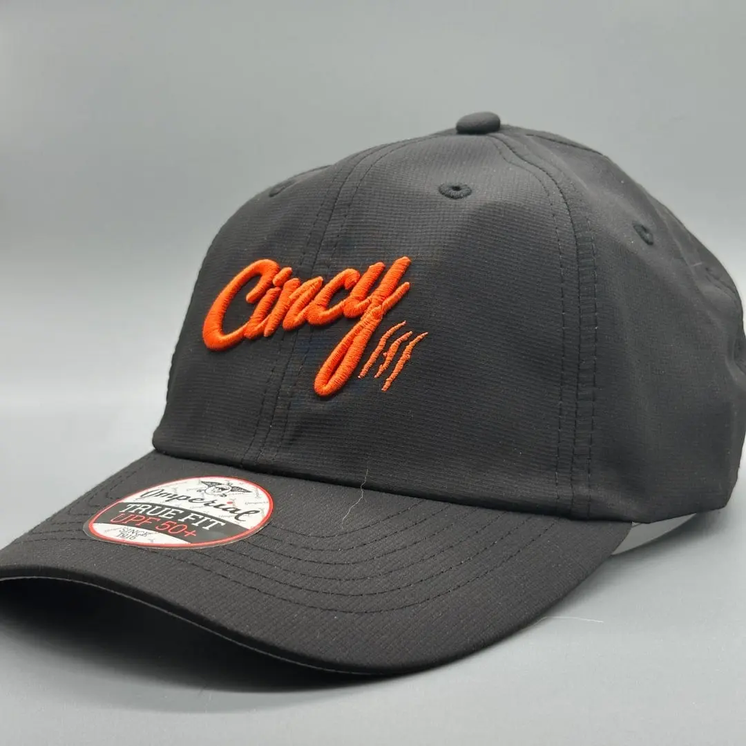 Charcoal Lightweight Performance hat with orange Cincy script and claw slashes on a grey studio backdrop