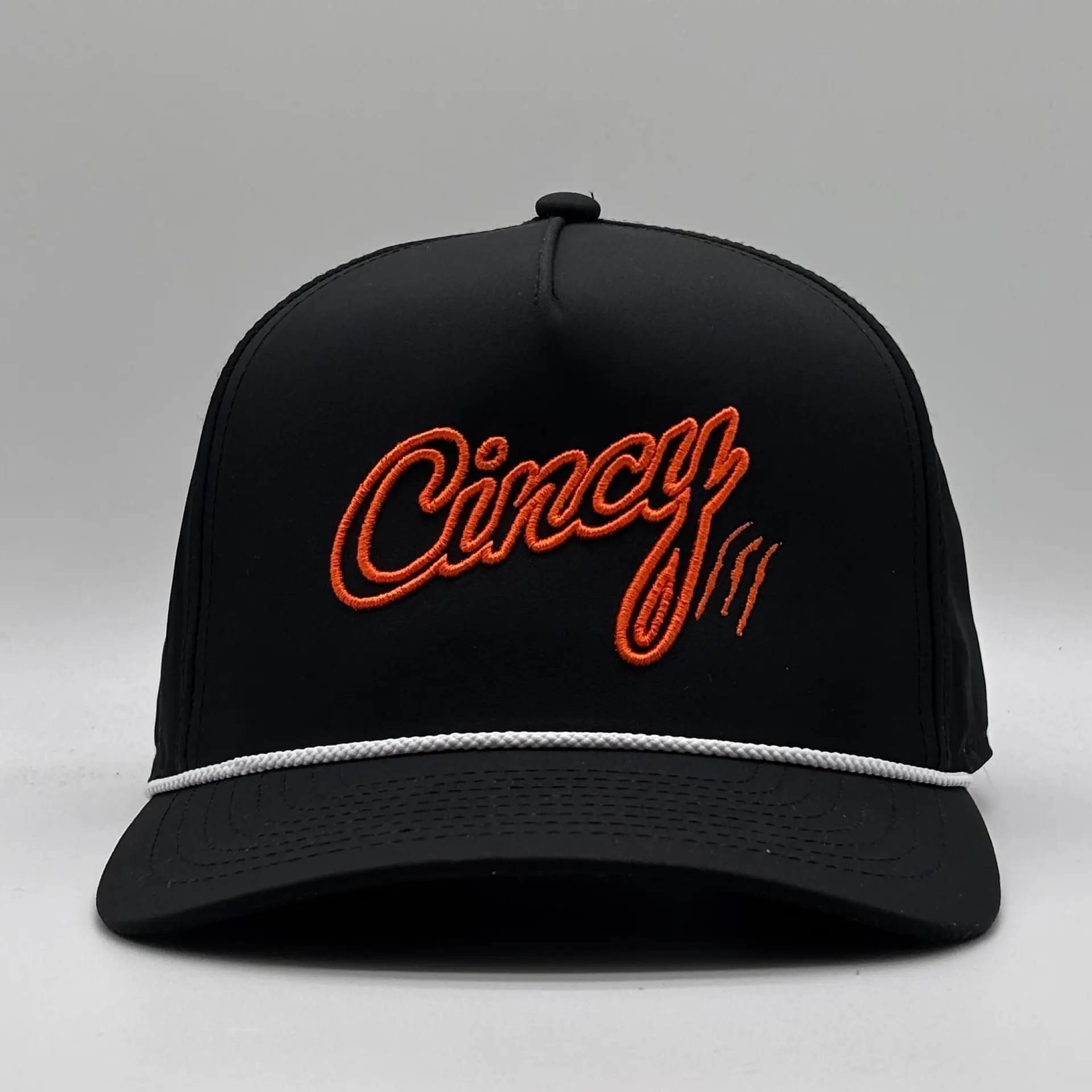 Front view of the black OG 5 Panel rope hat with orange 3D-outline Cincy script and a white rope on the brim