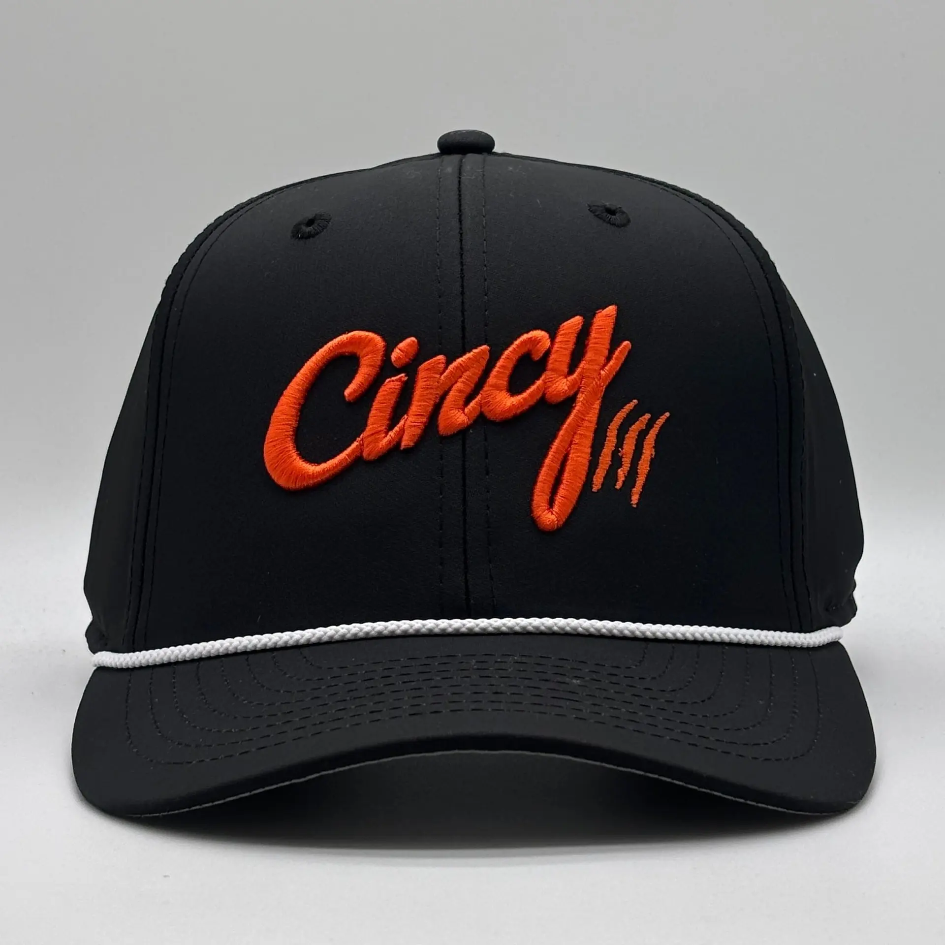 Front view of a black XL rope hat with orange Cincy script and claw slashes and a white rope on the brim